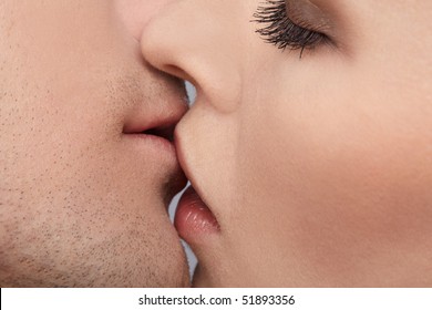 Close Up Portrait Of Young Caucasian Couple Kissing