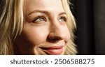 Close up portrait of young Caucasian female with beautiful eyes and smile on face. Pretty woman looks at sun smiling.