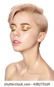 Close portrait of young girl with golden glitter eyeshadow