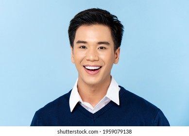 Close Up Portrait Of Young Handsome Smiling Asian Man Face On Light Blue Studio Background