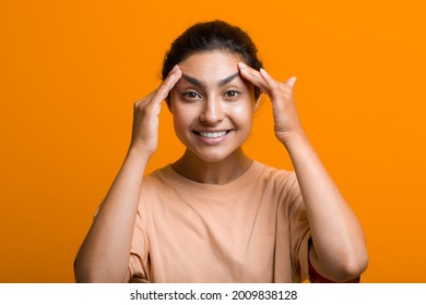 Close Up Portrait Of Young Indian American Woman Touching Face Skin Her Hands And Doing Self Yoga Face Gymnastics Massage