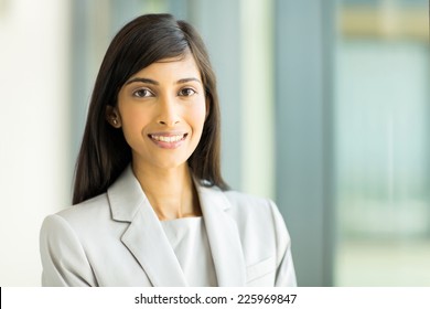 close up portrait of young indian business woman in modern office