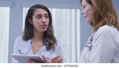 Close up portrait of young latina patient meeting with doctor about test results