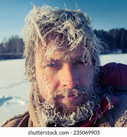 Close Up Portrait Of The Young Man With Frozen Icy Hairs On Head And Beard