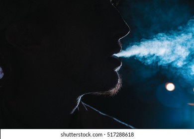 Close up portrait of young man smoking cigarette