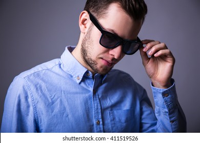 Close Up Portrait Of Young Man In Sunglasses Over Gray Background