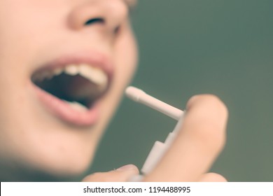 Close Up Portrait Young Teenager Using Sore Throat Spray  Into Open Mouth