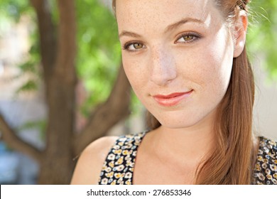 Close up portrait of a young tourist woman smiling in a leafy street on holiday, exterior. Travel and lifestyle summer vacation, outdoors park. Smart woman, lifestyle. - Shutterstock ID 276853346