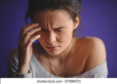 Close up Portrait of young woman with headache