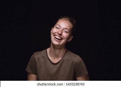 Close up portrait of young woman isolated on black studio background. Photoshot of real emotions of female model. Smiling, feeling crazy happy, laughting. Facial expression, human emotions concept.