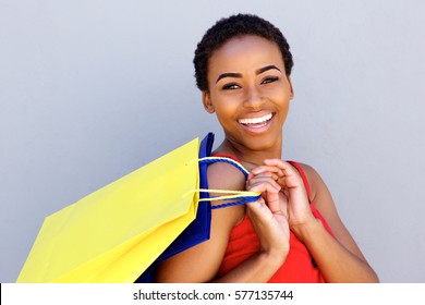 Close up portrait of young woman smiling with shopping bags
