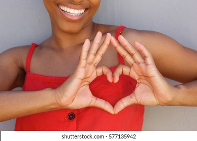 Close Up Portrait Of Young Woman Smiling With Heart Shape Hand Sign 