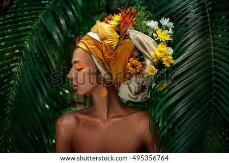 close up portrait of young woman in turban with flowers 