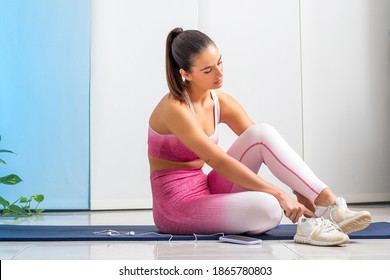 Close up portrait of young woman wearing leotards getting ready for fitness workout at home.