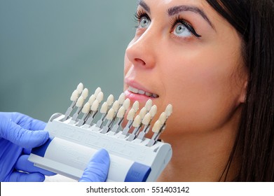 Close up portrait of Young women in dentist chair, Check and select the color of the teeth.