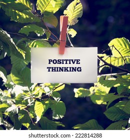 Close up Positive Thinking Message on White Small Paper Clipped on Green Plant Outdoor.