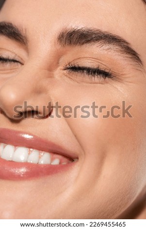 close up of positive young woman with flawless and natural makeup