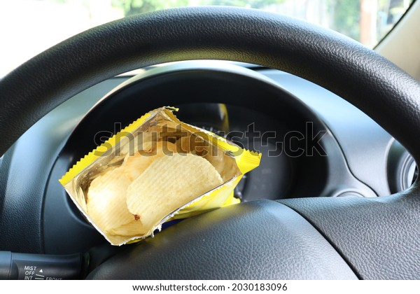 Close up of potato\
chips in the bag and car