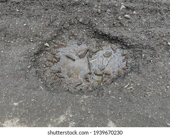 Close Up Of A Pothole On A Quiet Country Tarmac Road In Rural Devon, England, UK