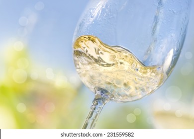 Close up of pouring white wine in a glass