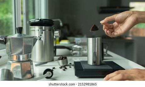 Close Up Powder Coffee On A Stainless Spoon With Hand People Pour Roasted Coffee For Espresso Coffee Into The Cup With Equipment Tool Brewing Italian Moka Pot, Coffee At Kitchen Home Preparation Drink