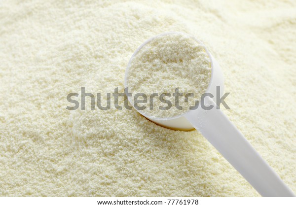 close up of powdered milk and spoon for\
baby on white background with clipping\
path