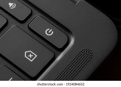 Close up of the power button on a black laptop computer.
