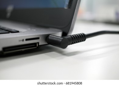 Close Up Power Cable Connected On Laptop