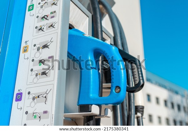 Close up power cord for electric car.\
Green station.Power supply for electric car battery\
charging.Selective\
focus.Closeup.