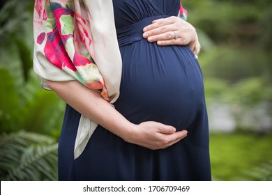 Close of Pregnant Married Woman's Belly in Blue Dress 