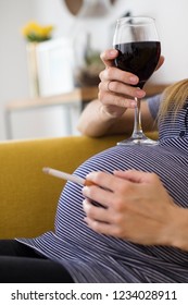 Close Up Of Pregnant Woman Smoking Cigarette And Drinking Wine