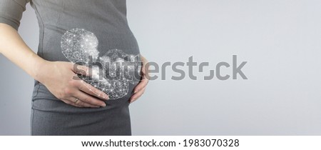 Close up of pregnant woman's belly with hologram fetus. Pregnancy, maternity concept concept. Close-up, copy space.
