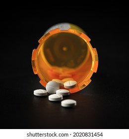 Close Up Of A Prescription Pill Bottle With White Pill Tablets. Concept For Addiction, Accidental Poisoning, Or Overdose And Suicide.