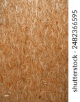 Close up pressed wooden panel background, seamless texture of oriented strand board - OSB wood