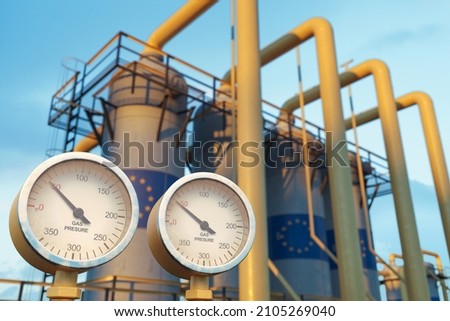 Close up of pressure gauge showing low gas pressure at natural gas factory with European union flag on the gas tanks
