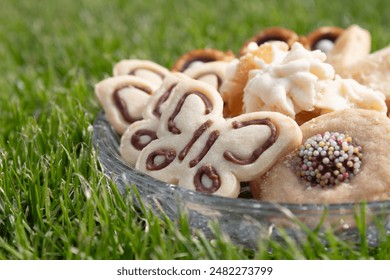 Close up of a pretty assortment of delicious cookies on green grass - Powered by Shutterstock