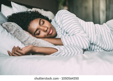 Close Up Of A Pretty Black Woman With Curly Hair Sleeping In Bed Closed Eyes