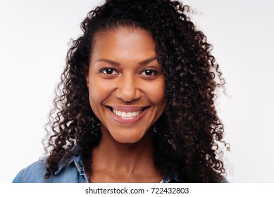 Close Up Of Pretty Curly Woman Smiling At Camera