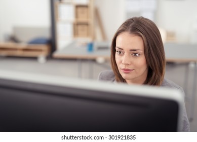 Close Up Pretty Office Woman Sitting At Her Desk, Looking Straight At Her Computer Screen While Working.