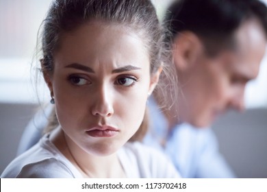 Close up of pretty sad woman feel upset after family fight, spouses avoid talking after disagreement, offended wife angry having dispute or misunderstanding with husband, mad spouses ignore each other