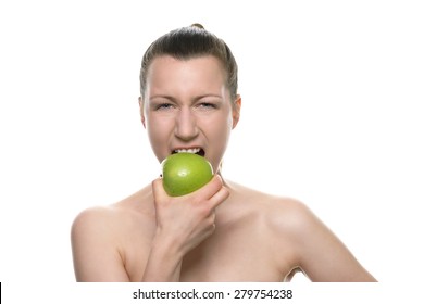 Close up Pretty Young Bare Woman Biting Fresh Healthy Green Apple While Looking at the Camera. Isolated on White Background.