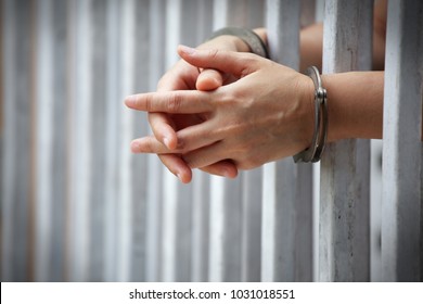 close up of prisoner hands in jail background.