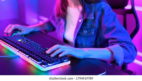 close up of pro cyber sport gamer play game with RGB keyboard and mouse - Shutterstock ID 1794919789