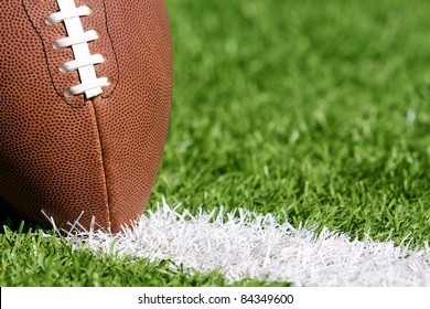 Close Up Of A Pro Football On The Yard Line Of A Field With Shallow Depth Of Field And Room For Copy