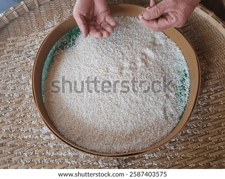 Close up of the process of Separating  stone fragments from glutinous rice.
