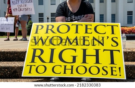 Close up of a Pro-Choice protest sign signifying ongoing protests across the United States with other signs in the background.