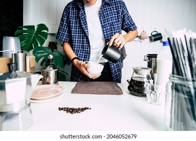 close up The professional barista poured milk. making hot coffee with equipment, tool brewing on the bar at kitchen home - Powered by Shutterstock