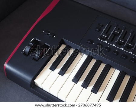 close up of professional black midi controller keyboard with pitch and modulation wheels