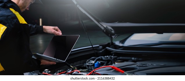 Close Up Of Professional Car Mechanic Working In Auto Repair Service. Automobile Computer Diagnostic Concept.