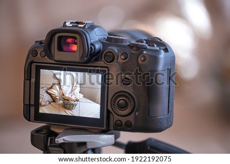 Close up professional digital camera on a blurred background. The concept of technology for working with photos and videos.